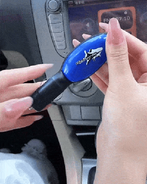 Hand plugging the Auto Fuel Saver Device into the 12V socket